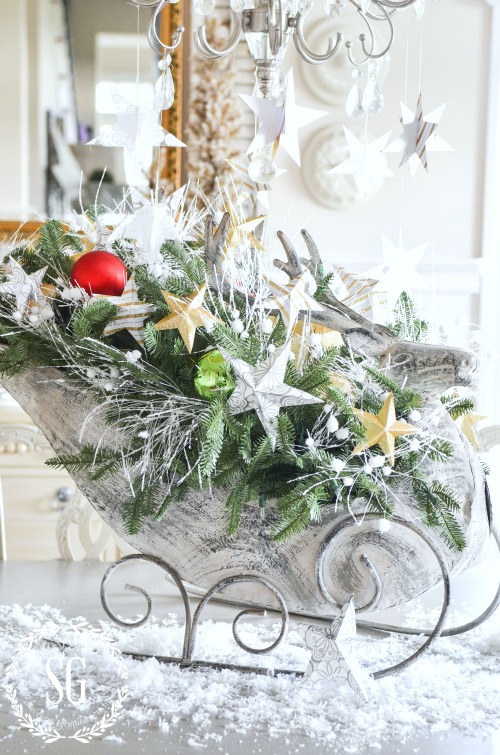 REINDEER CENTERPIECE- Table centerpiece with greens and paper stars.