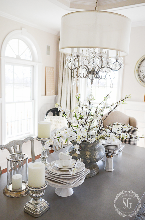 EARLY SPRING IN THE DINING ROOM- Budding branches and white dishes. Capturing the beauty of the first signs of spring.