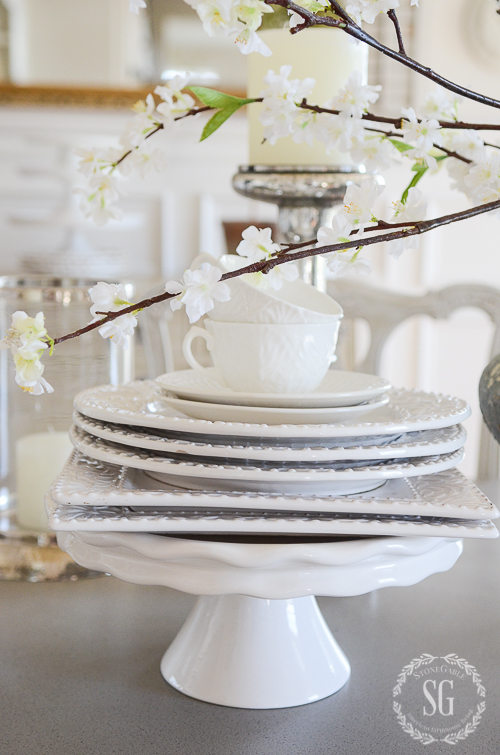 EARLY SPRING IN THE DINING ROOM- Budding branches and white dishes. Capturing the beauty of the first signs of spring.