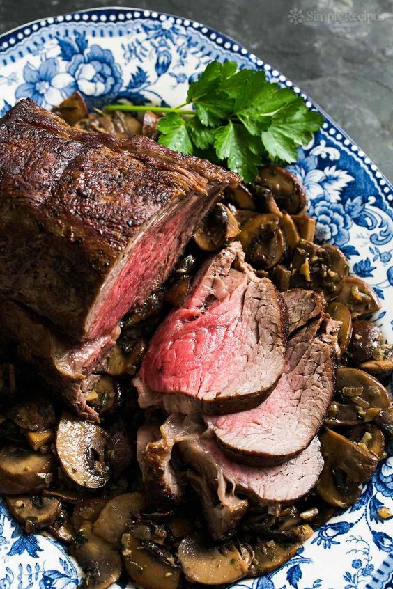 a beautiful beef roast surrounded with mushrooms