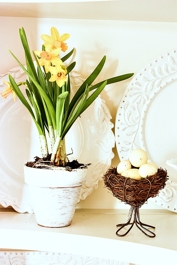 faux daffodils in a little white pot