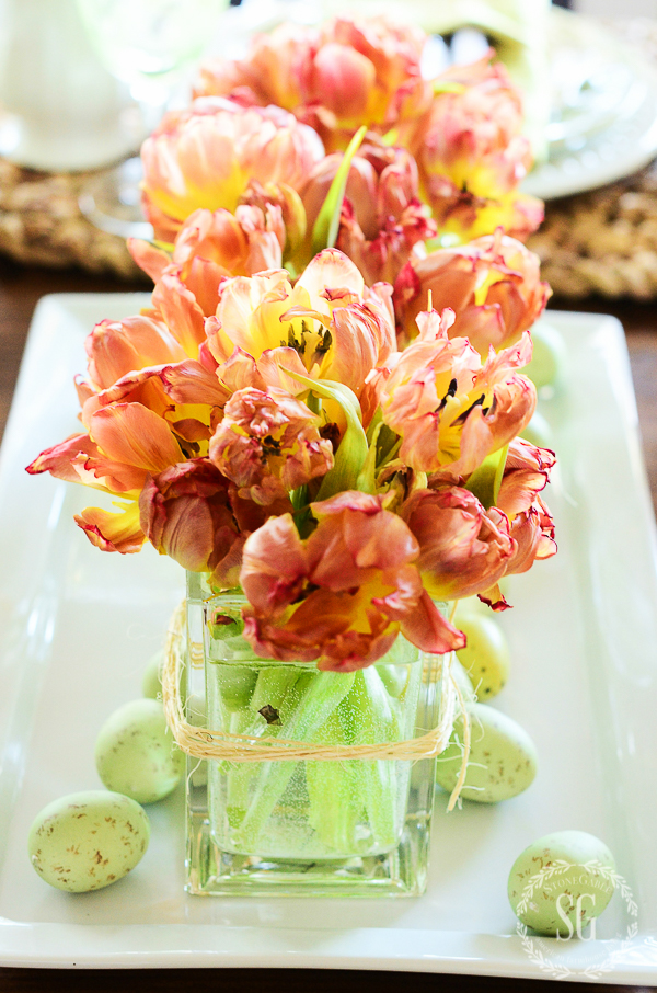 an easy last minute easter idea is cut tulips in a pretty square vase.