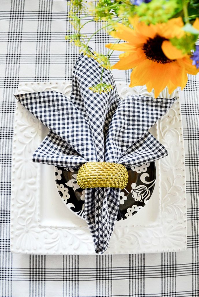Fleur De Lis napkin fold on a pretty black and white table