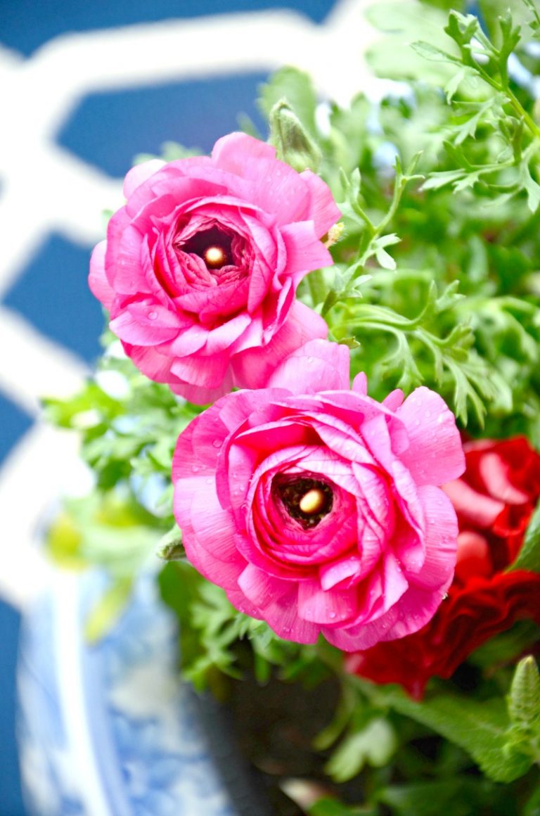pretty pink flowers in a blue and white ceramic container garden