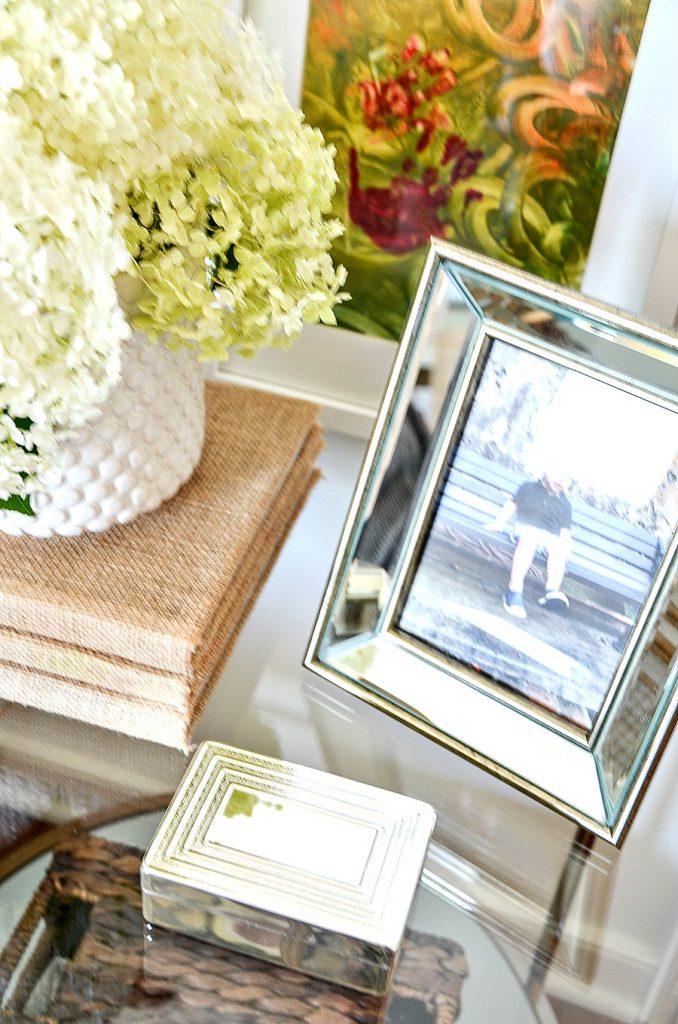 silver mirrored picture frame on a round nightstand