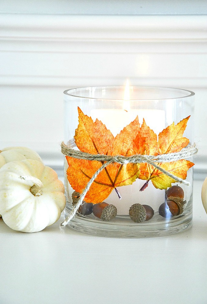 candle holder with a leaf tied to the front of it