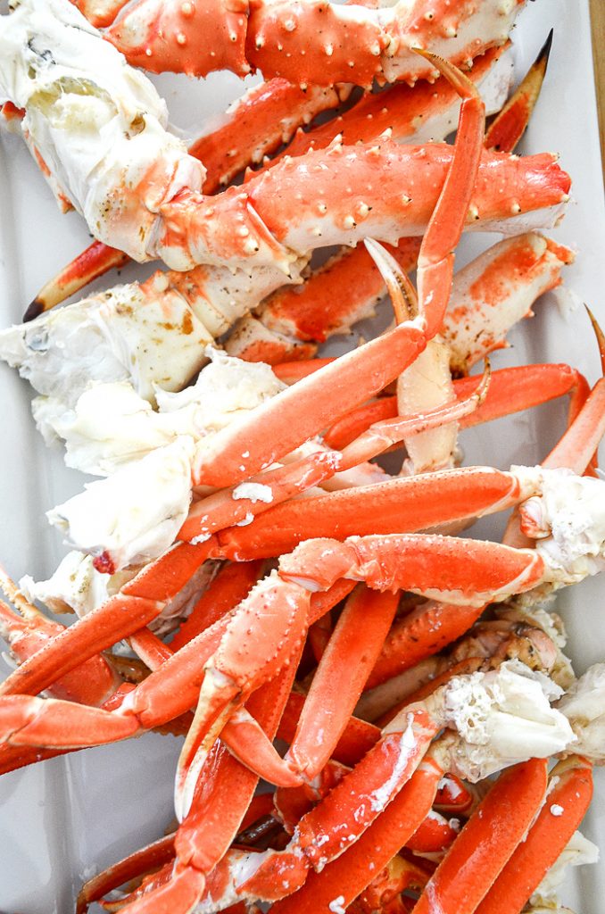King crab and snow crab on a platter that go into a Low country Boil.