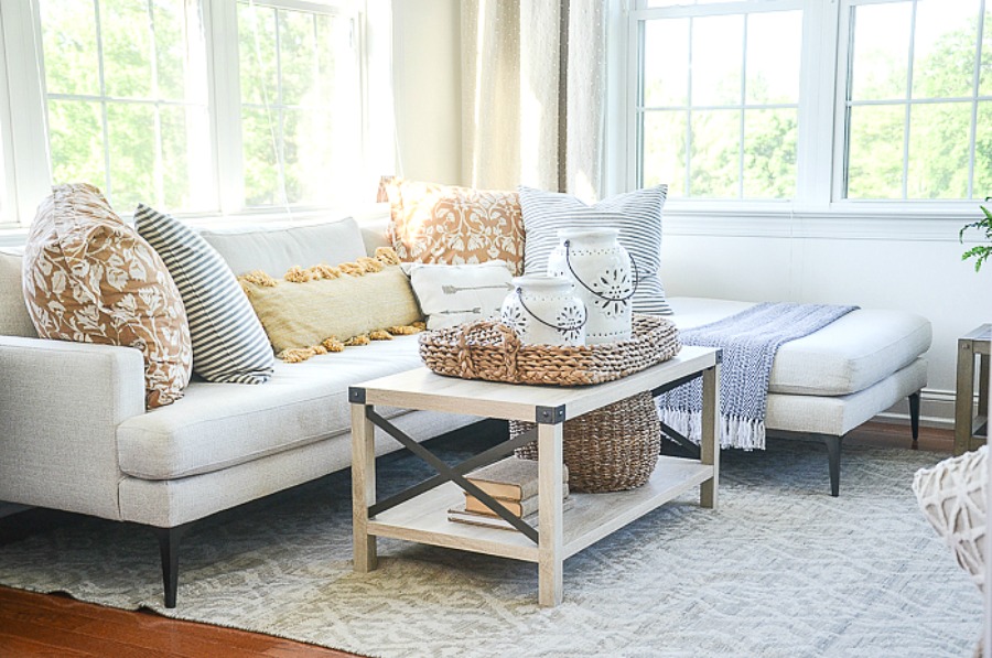 sectional with summery pillows on it