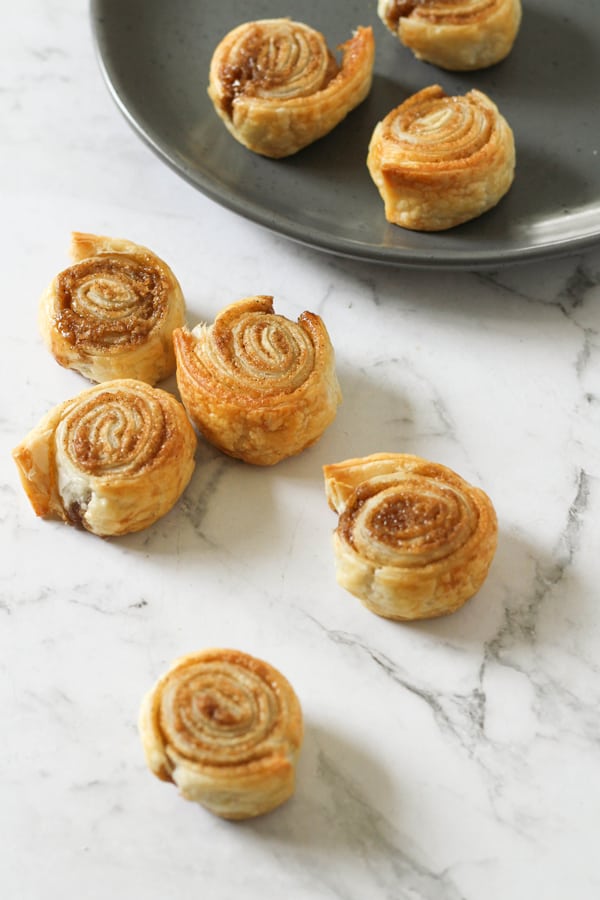 beautiful little cinnamon roll ups on a marble counter