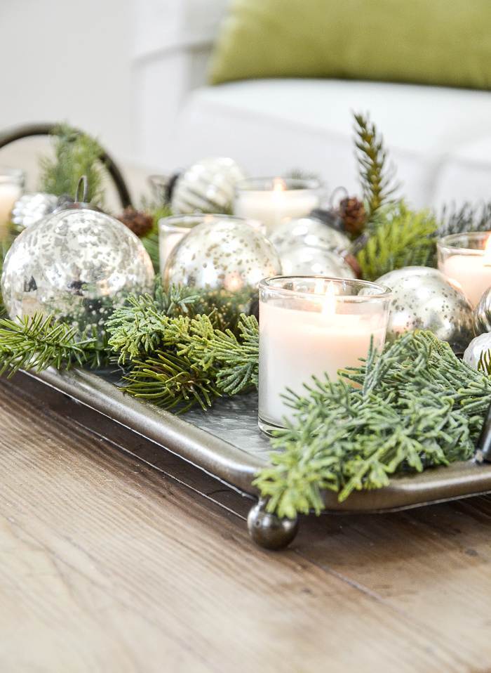 VOTIVE CANDLES ON A TRAY WITH GREENS AND ORNAMENTS