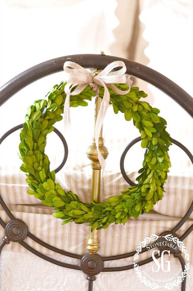 KEEPING LIVE CHRISTMAS GREENS FRESH-  BOXWOOD WREATH TIED TO A BED