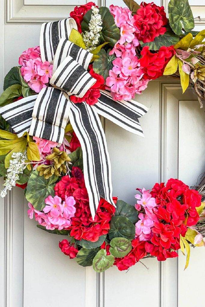 a geranium wreath on a front door