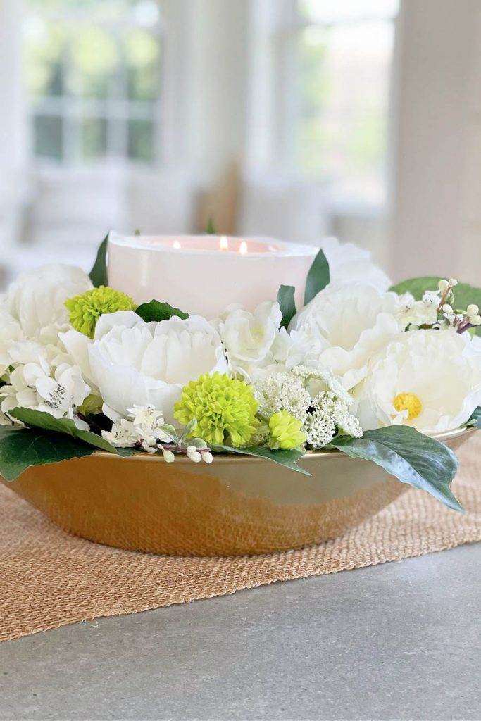 ACCENT DECOR- a candle and flowers in a gold tone bowl.
