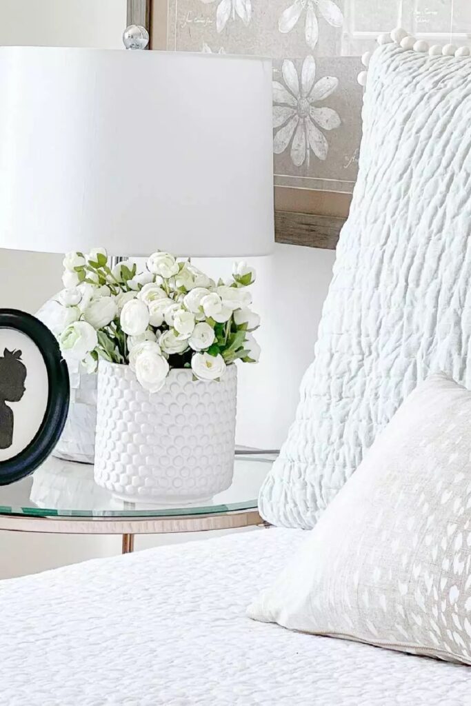 IMAGE OF A NIGHTSTAND WITH WHITE FLOWERS ON IT