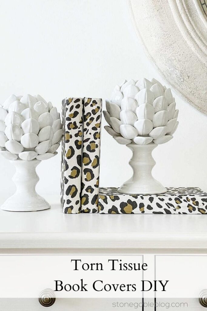 LEOPARD TORN TISSUE BOOKS COVERS BETWEEN TWO WHITE ARTICHOKE BOOK ENDS