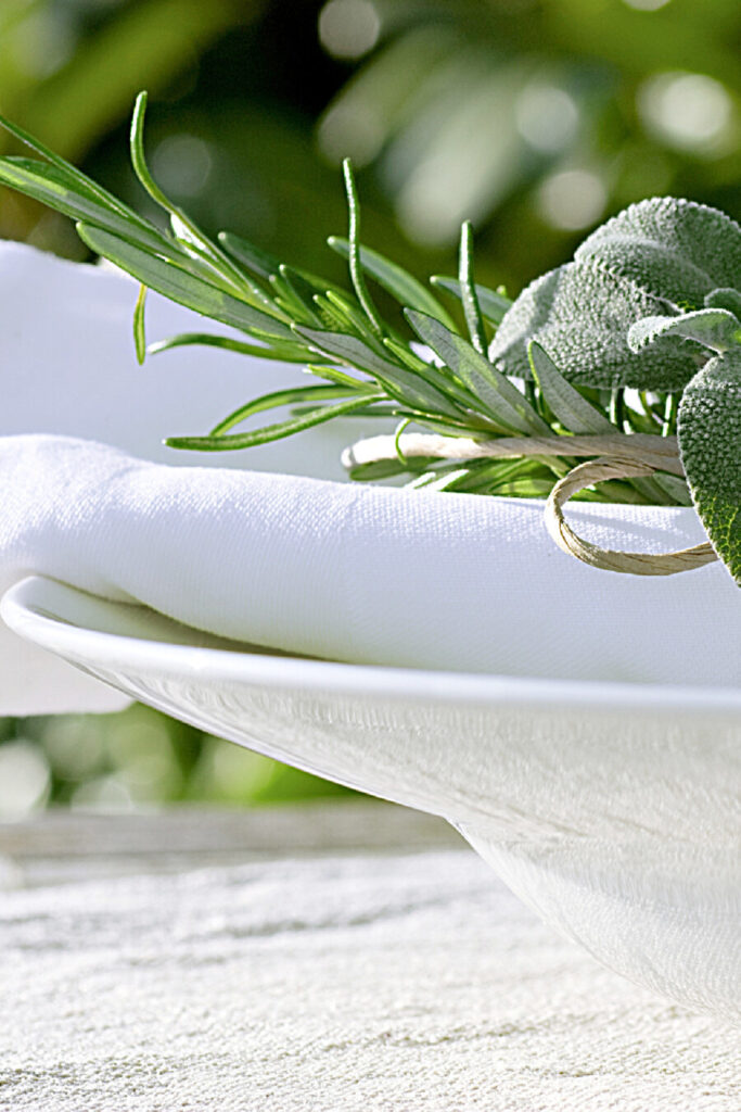 ON THE MENU WEEK OF JULY 11TH- HERB BUNDLES ON A WHITE PLACE SETTING