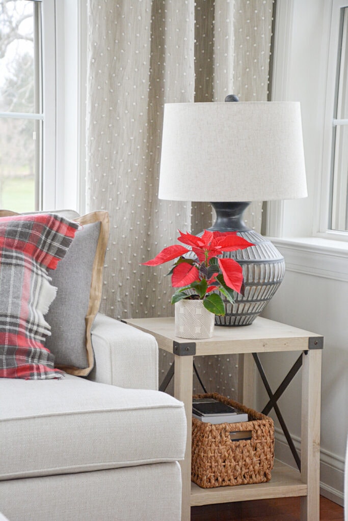 decorating a small space for Christmas- poinsettia on an end table