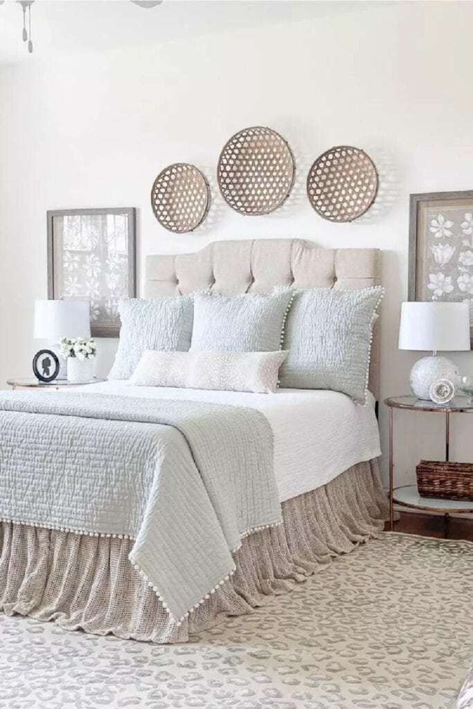 ACCENT DECOR- a bed with a group of baskets above it