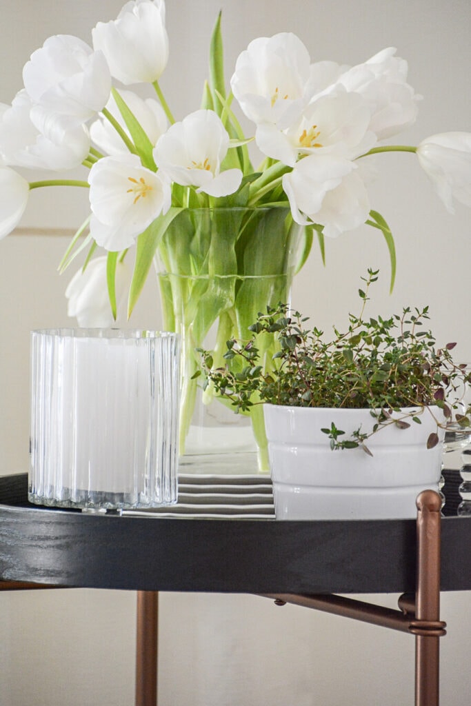 ACCENT DECOR- flowers on a stack of white dishes