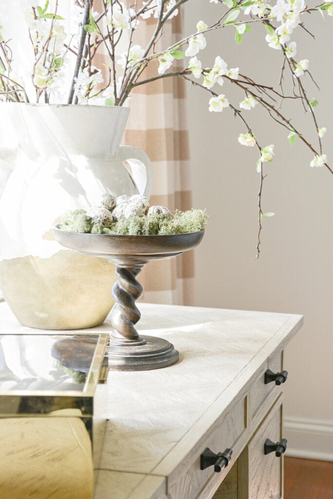 spring home tour- twisted pedestal with small eggs in it