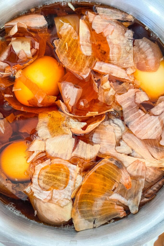 onion skin dyed Easter eggs-EGGS AND ONION SKINS IN A SAUCEPAN