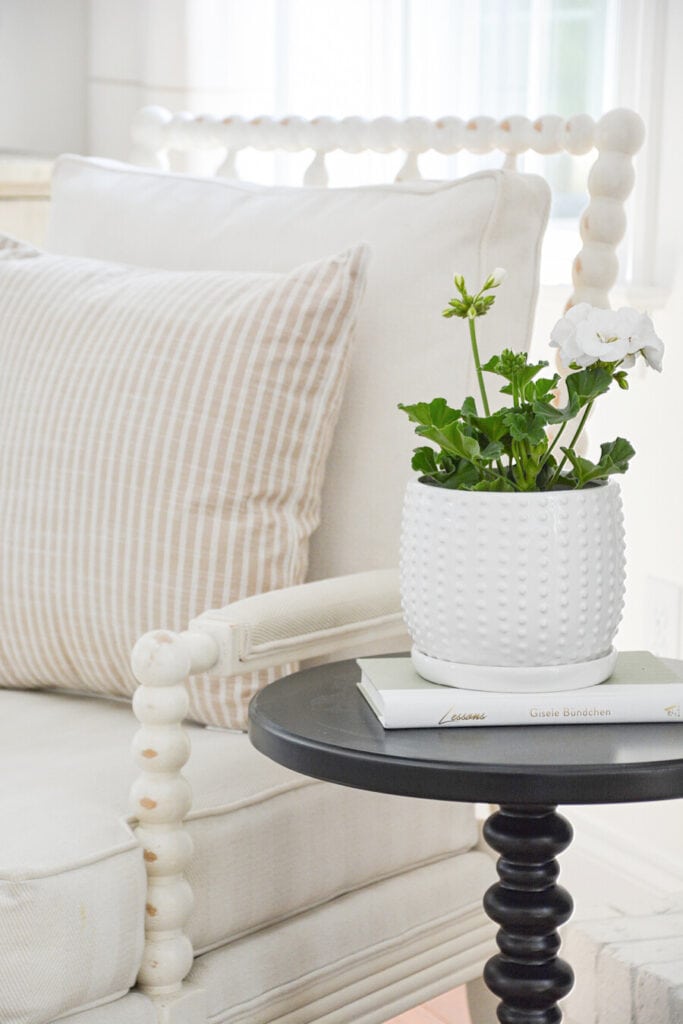 WHITE GERANIUM IN A HOBNAIL PLANTER ON A LITTLE TABLE 