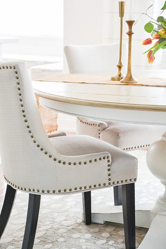 small dining room - round dinner table with nailhead chairs.