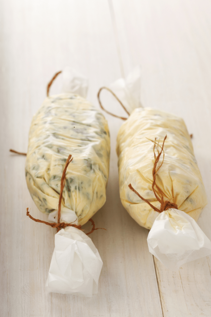 two logs of herb compound butter- Canva images