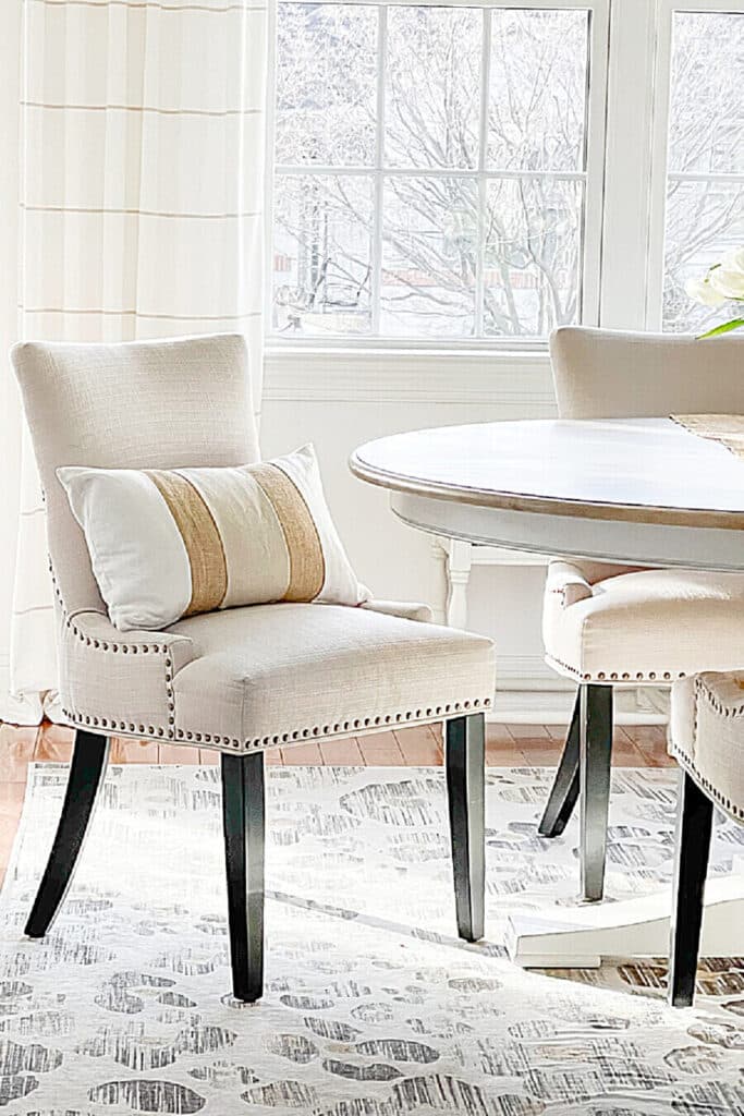 an upholstered dining chair pulled out from the table