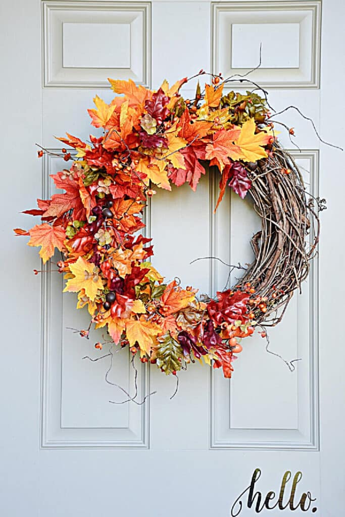 Wreath with lots of colorful leaves on it.