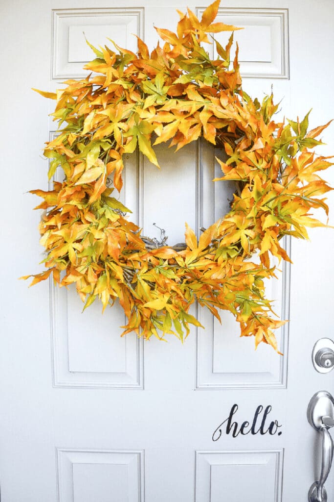 leafy wreath for fall hanging on a front door.