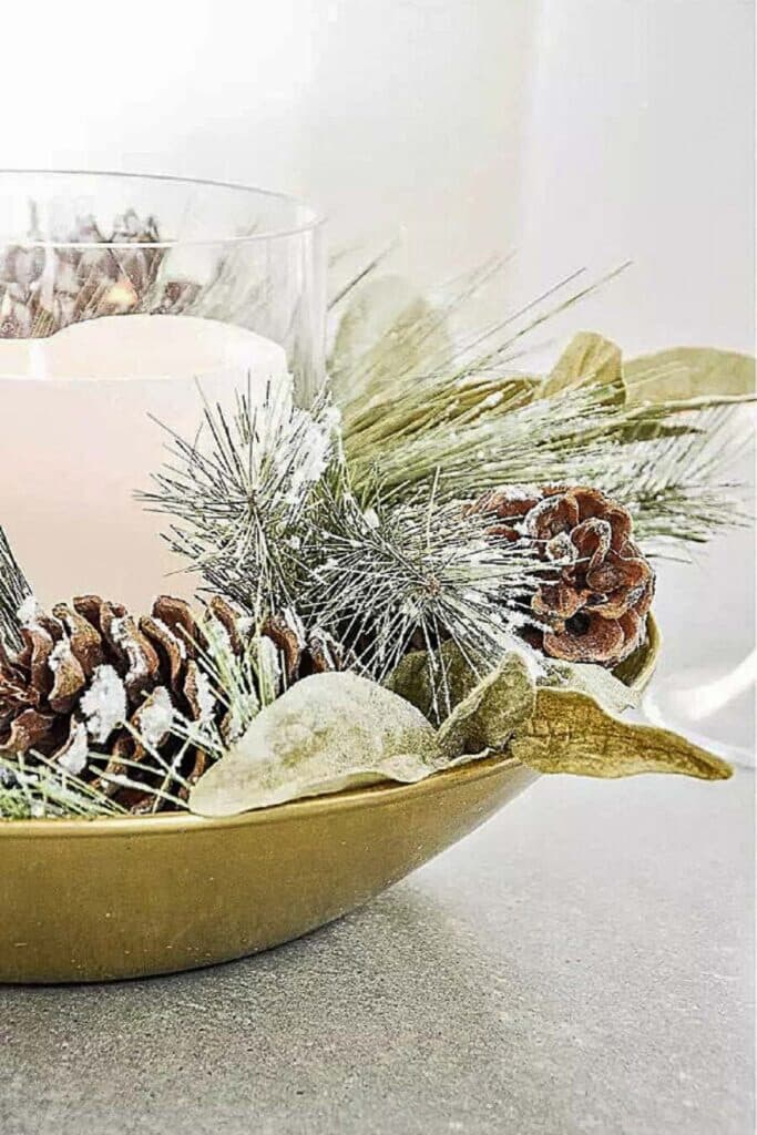 DECORATING WITH PINECONES-bowl with greens and pinecones and a candle