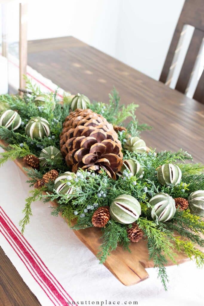 natural centerpiece with pinecones and dried limes.