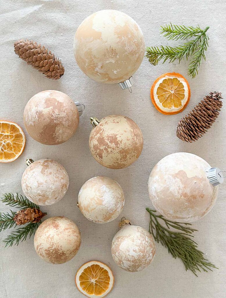 distressed Christmas balls with dried oranges, pinecones and greens.