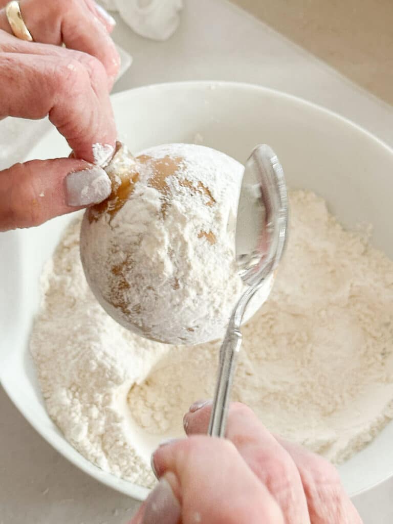 adding flour to the ball