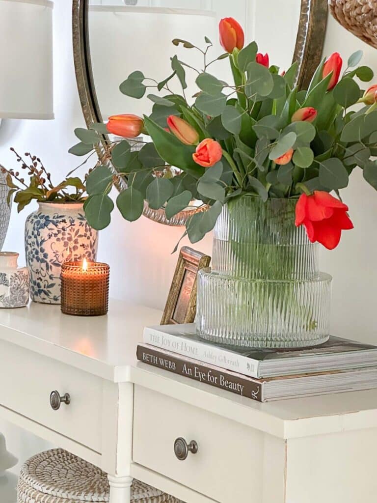 1 FOYER TABLE DECOR- tulips on one end of a console 