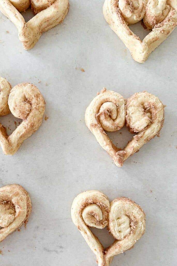 dough hearts on a parcment lined baking sheet