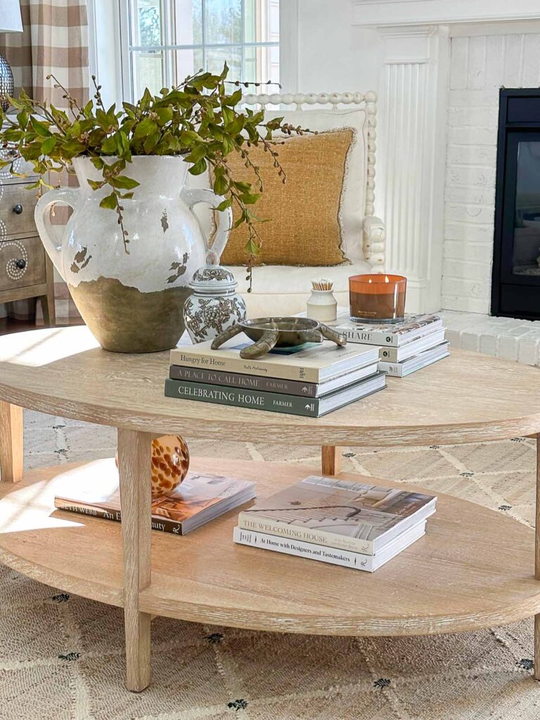 Decorating A Coffee Table- bottom shelf on a coffee table with decorating books