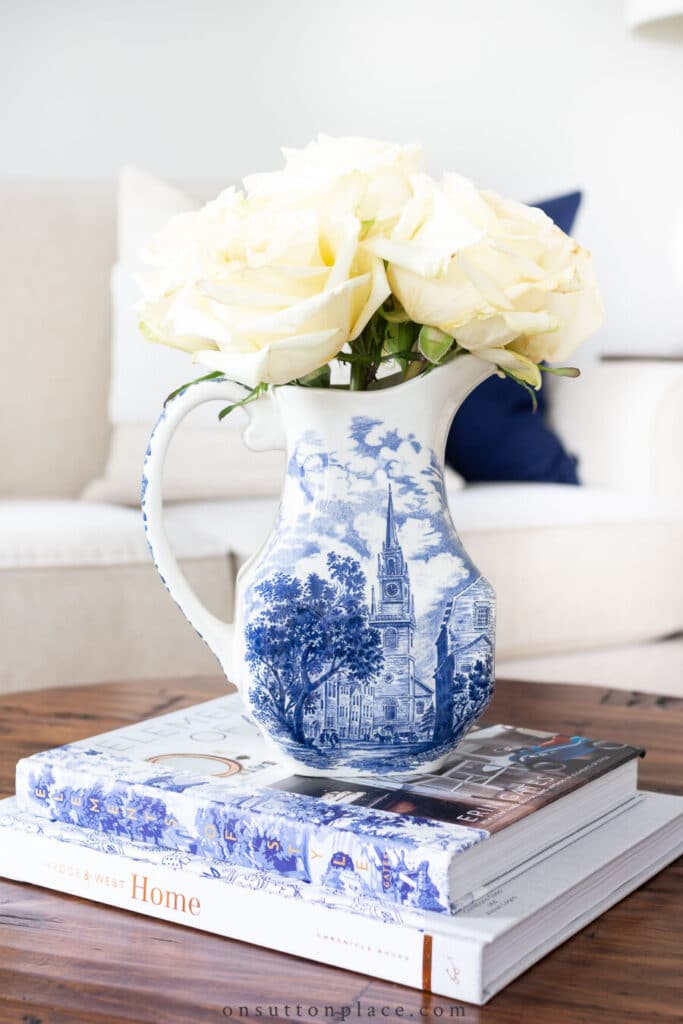 blue and white pitcher with white roses