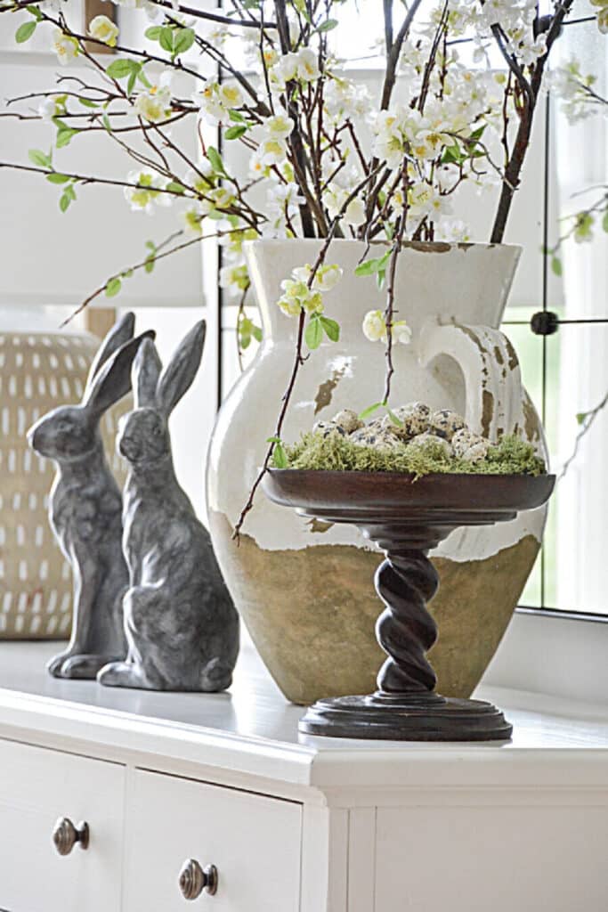 spring branches and rabbits on a white buffet