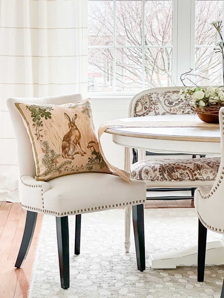 large statement pillow in the dining room for spring.
