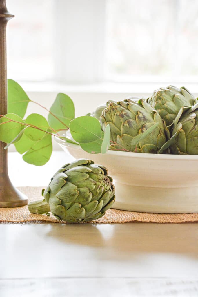 close up of artichokes in a shallow bowl. - Spring centerpieces