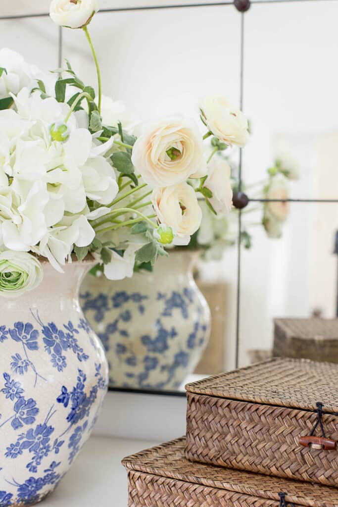 beautiful faux flowers in a blue and white pottery vase