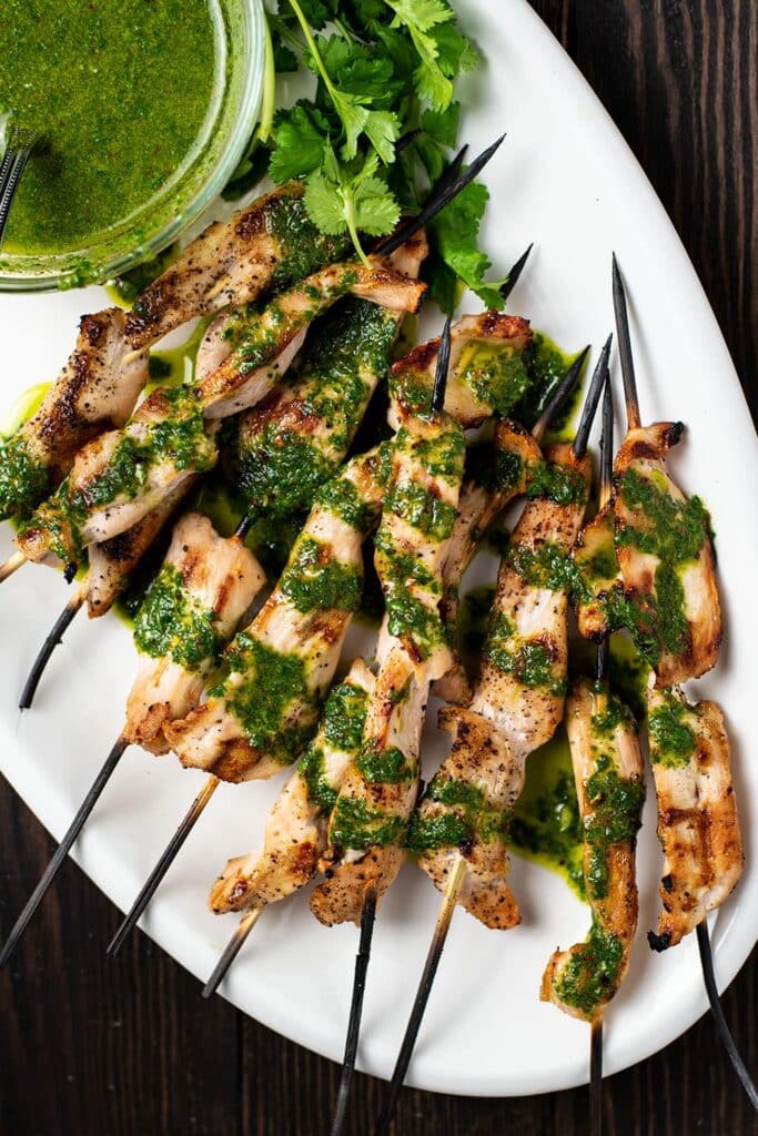 chicken skewers and chimichurri sauce.