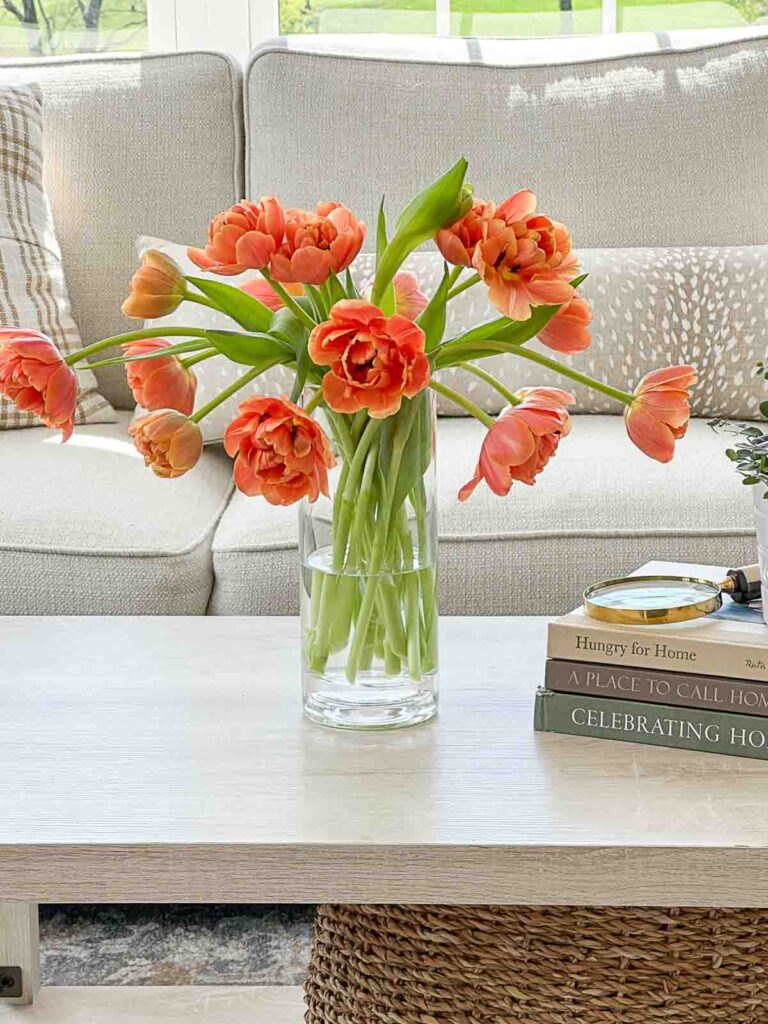 TULIPS: orange tulips on a coffee table